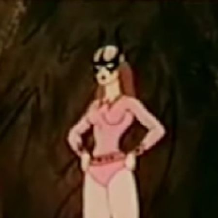 Web Woman is wearing a pink dress with black mask covering her eyes.